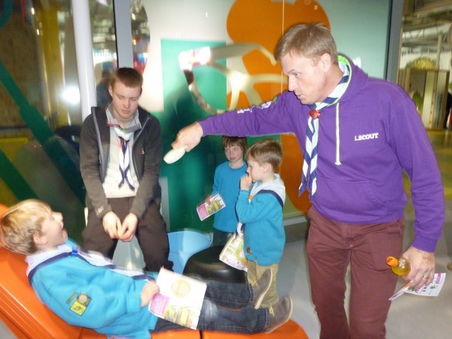 A volunteer is pretending to check a beaver scout's mouth.